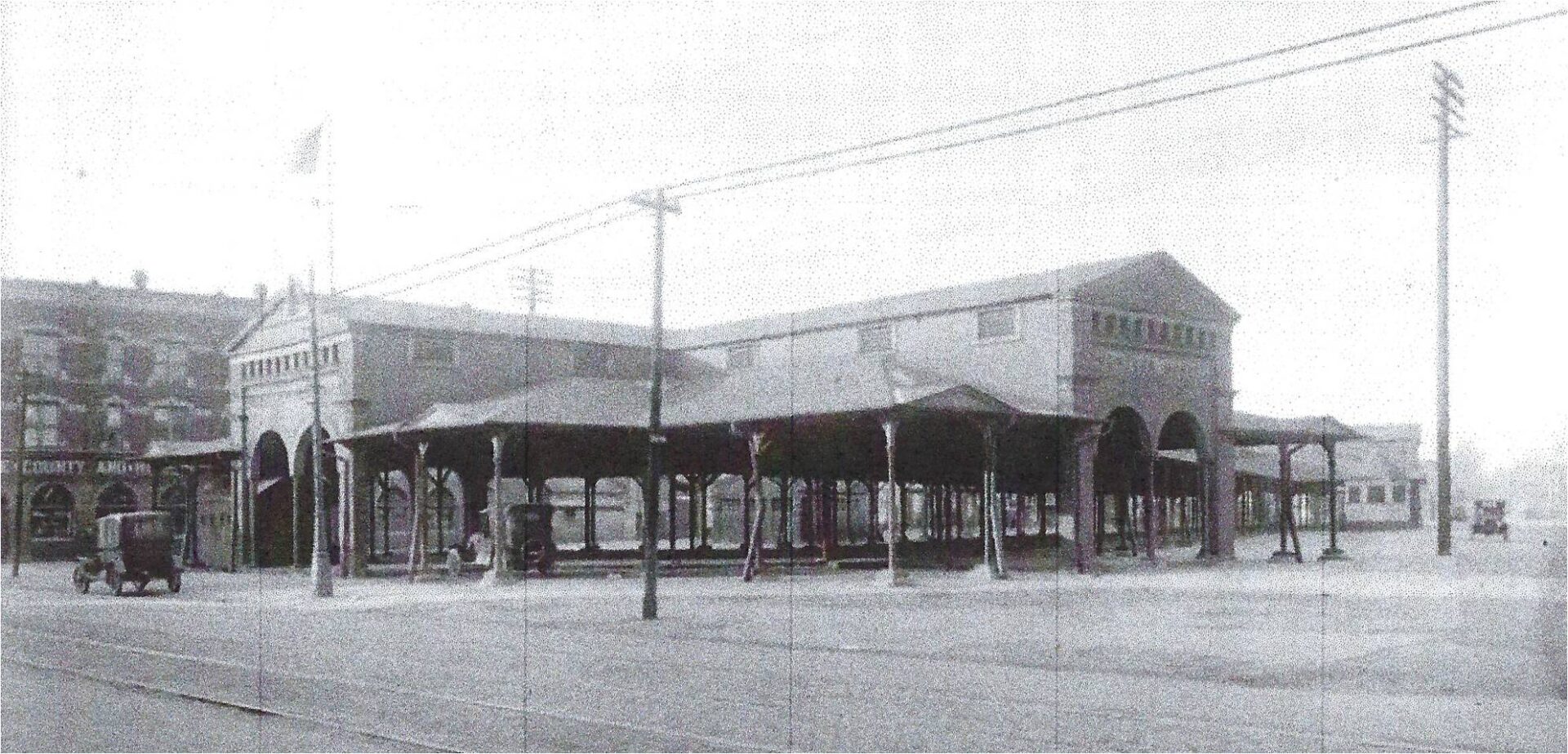 A black and white photo of an old train station.