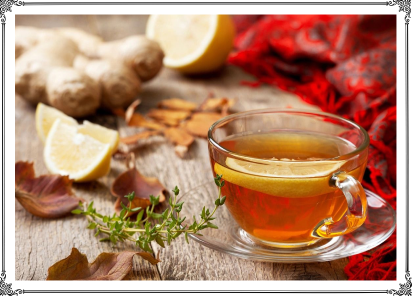 A cup of tea with lemon and ginger on the table.