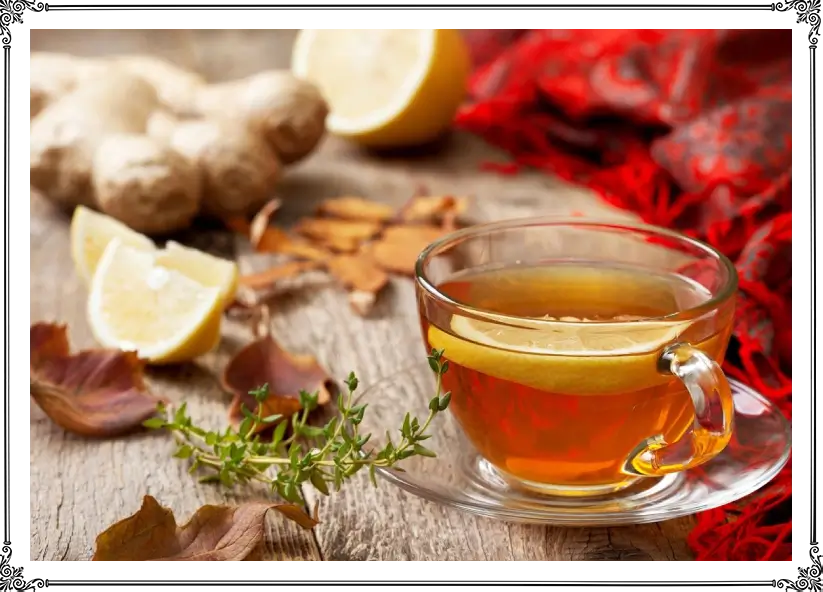 A cup of tea with lemon and ginger on the table.